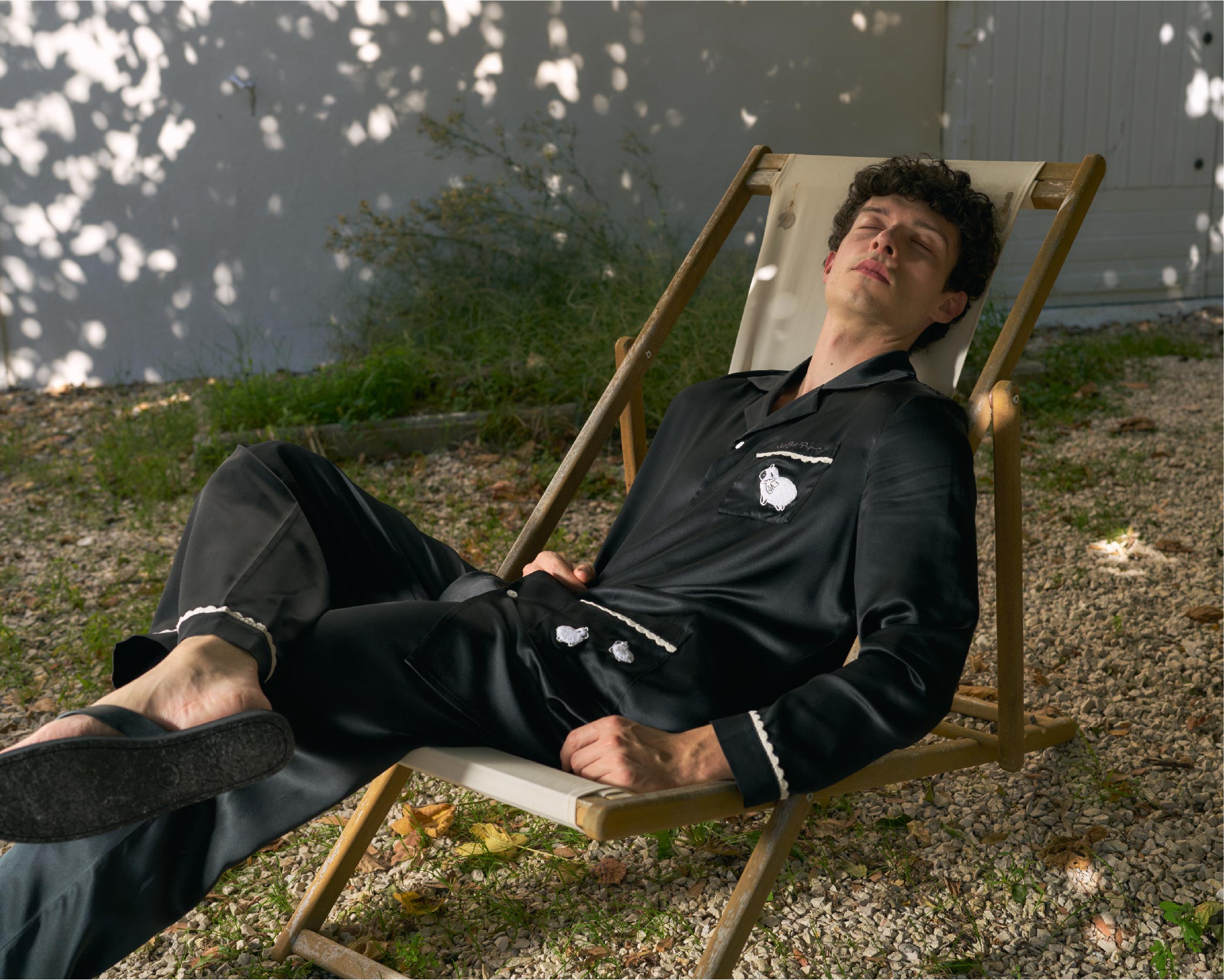Man relaxing on a wooden deck chair outdoors wearing Silk Pajama