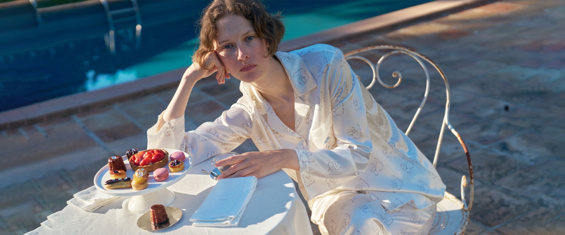 Model wearing Kiki 22 momme mulberry silk pajamas in outdoor lifestyle setting