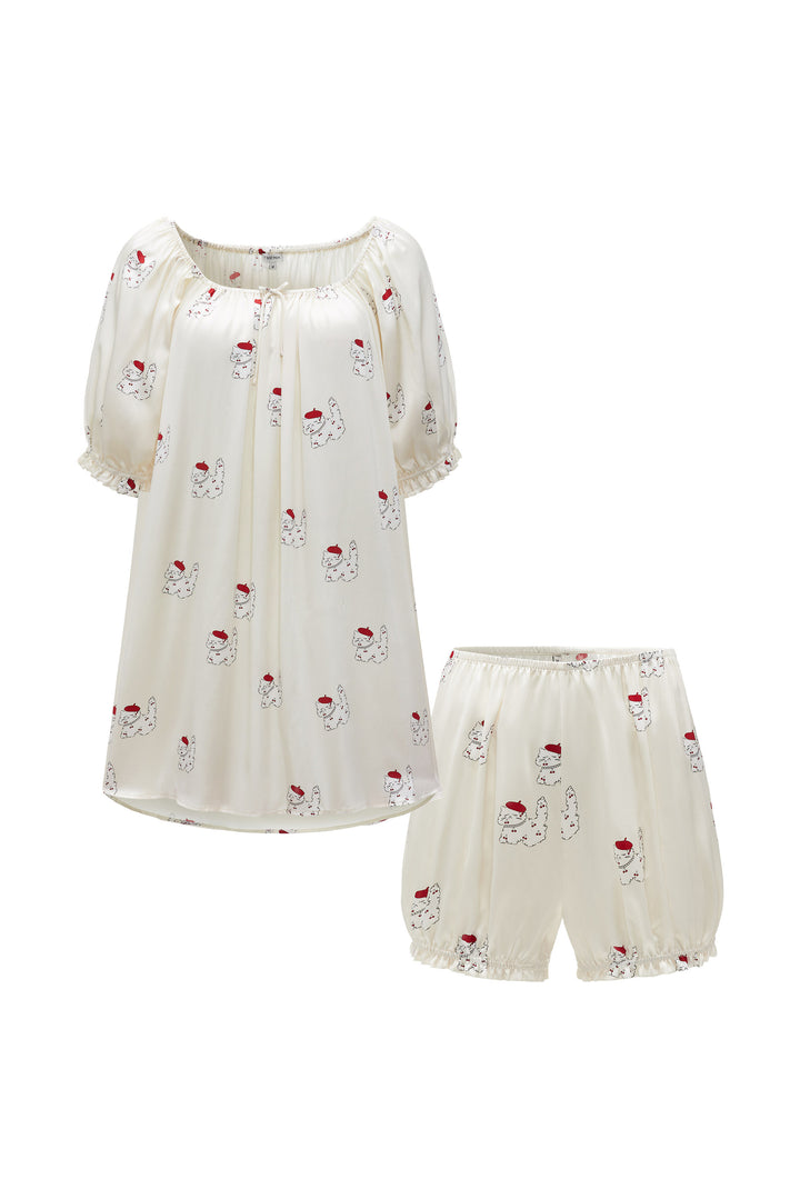White silk pajama set with cheery cat print on a white background