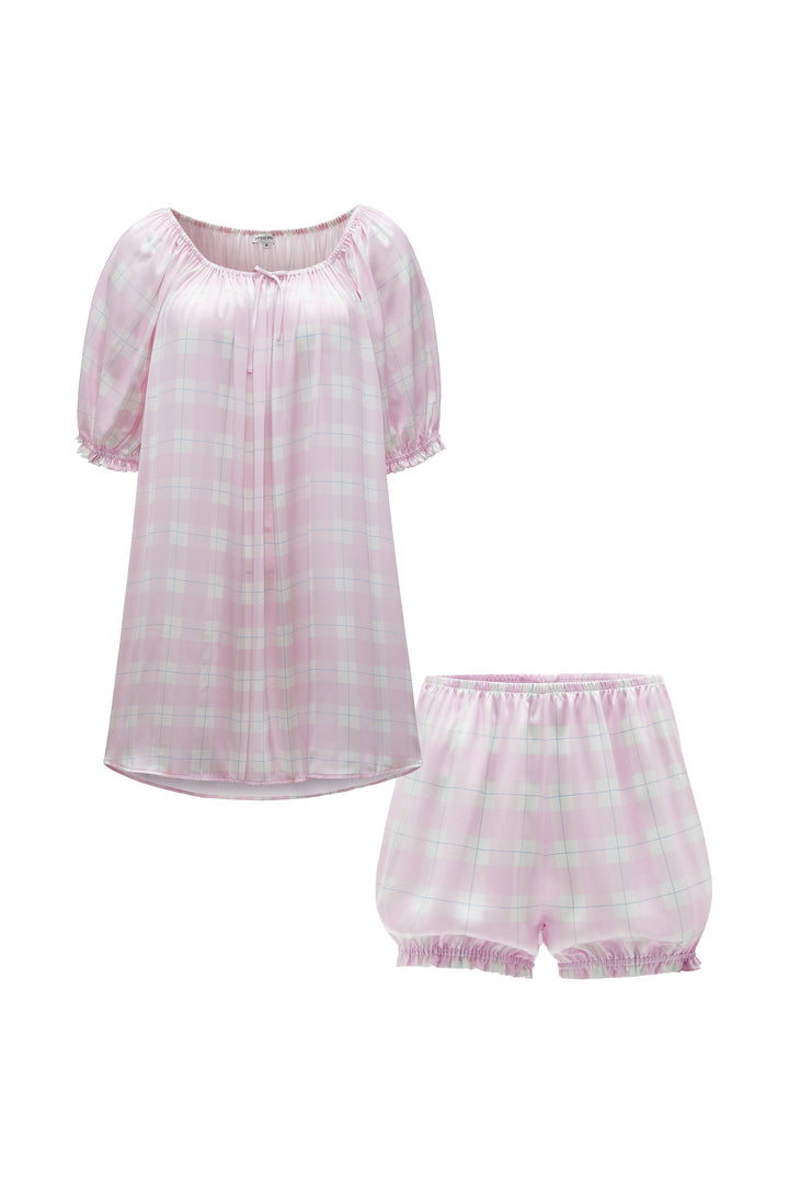 Pink checkered silk pajamas set with top and shorts on a white background