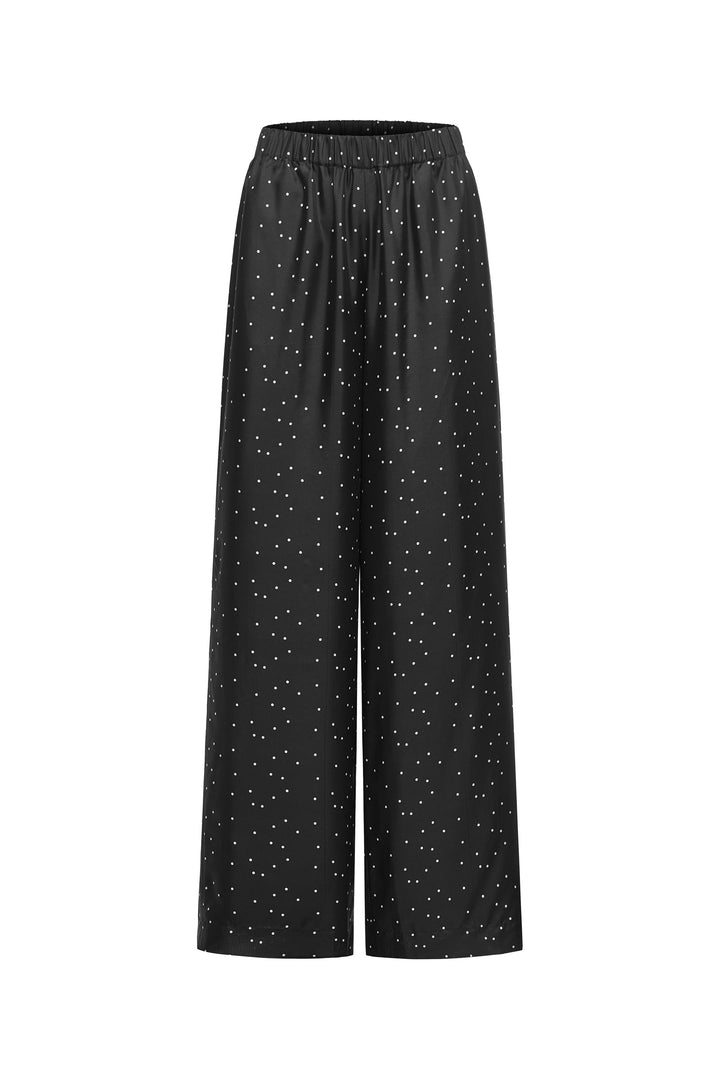 Black wide-leg silk pants with a subtle pattern on a white background