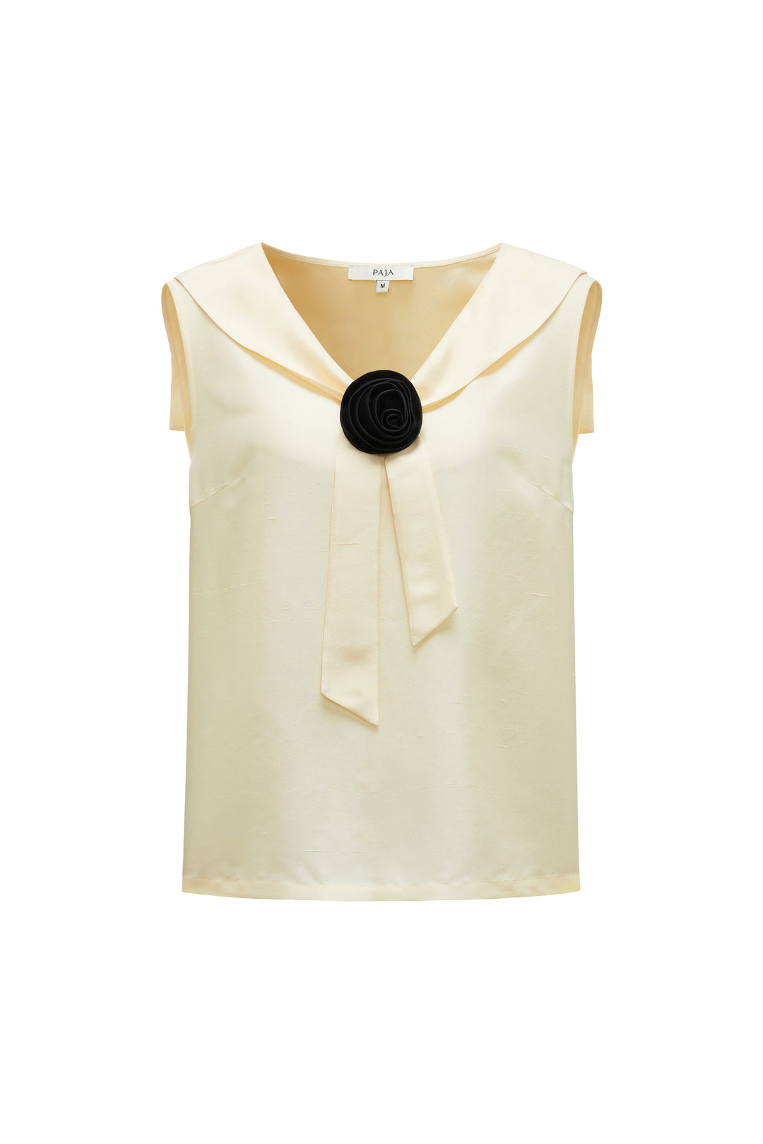 light yellow silk sleeveless top with a black flower accessory on a white background